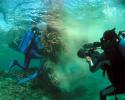 Director of Photography, Paul Atkins, films Chief Diver, Blair Mott as he helps the NOAA Marine Debris team pull up a net inside the lagoon at Sand Island, Midway Atoll. © Tom Ordway, Ocean Futures Society Marine Debris